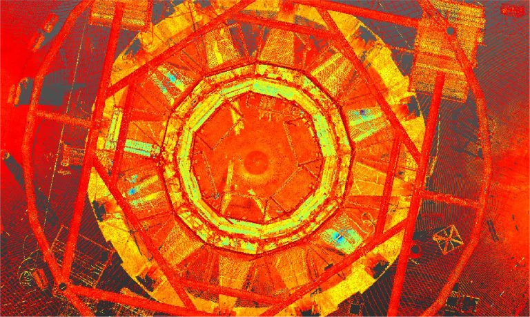 Nube de puntos de estructura con círculos concéntricos y formas geométricas en tonos ardientes de rojo, naranja y amarillo del NAICM de Texcoco visto desde arriba