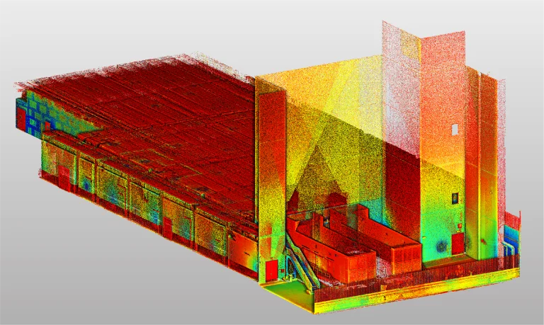 Una colorida nube de puntos 3D del interior de un edificio BOVIS, que muestra elementos estructurales detallados con puntos rojos, amarillos, verdes y azules para representar las diferencias de profundidad y elevación