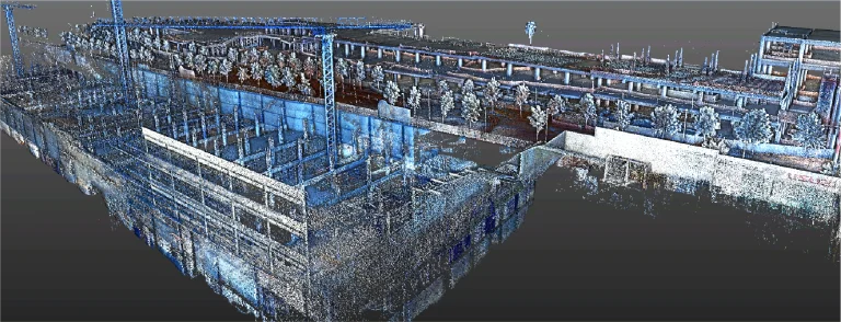 Una nube de puntos digital muestra el Centro Comercial Punto Sur en construcción en primer plano, con árboles, edificios y vehículos al fondo. La imagen presenta una llamativa combinación de colores azul y gris