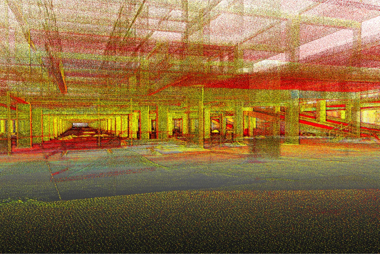 Una colorida nube de puntos escaneada de la estructura interior del Centro Comercial Punto Sur, que muestra columnas, vigas y espacios abiertos en tonos rojos, amarillos y verdes con aspecto de cuadrícula y capas transparentes superpuestas.