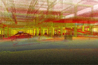 Una colorida nube de puntos escaneada de la estructura interior del Centro Comercial Punto Sur, que muestra columnas, vigas y espacios abiertos en tonos rojos, amarillos y verdes con aspecto de cuadrícula y capas transparentes superpuestas.