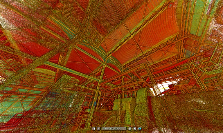 Nube de puntos muestra la estructura interior de Mina DIABRAS, un gran edificio industrial con vigas metálicas, viguetas y un tejado curvo, todo teñido de tonos rojos, verdes y amarillos