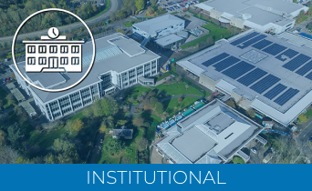 Aerial view of large institutional buildings with solar panels on the roofs, surrounded by trees. A Laser Scanner for Construction enhances site mapping. An illustrated building icon with a clock is overlaid top left; INSTITUTIONAL appears at the bottom.