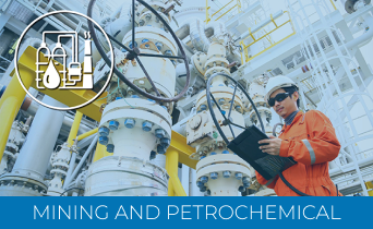 A worker in orange safety gear and a helmet uses a laptop and a Laser Scanner for Construction while inspecting large industrial pipes and valves at a mining and petrochemical facility. An icon of industry symbols appears in the top left corner.