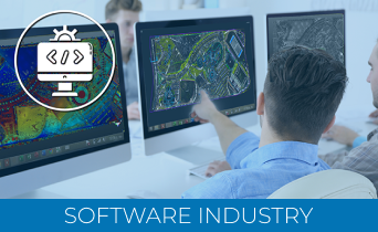 Two people sit at desks, examining software maps on their monitors. One points at a screen displaying a Laser Scanner for Construction. An icon of code overlays the monitor. Text at the bottom reads, Software Industry.