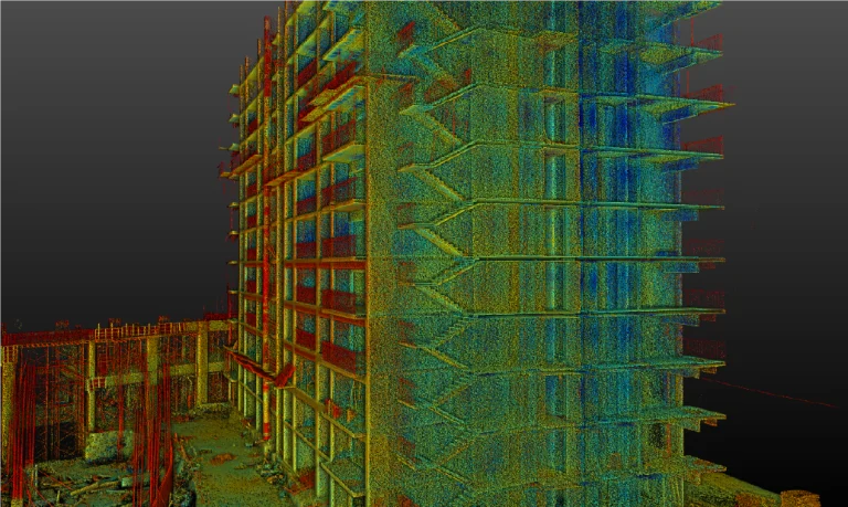 Nube de puntos 3D en color de un edificio de varias plantas en Desarrollo de Vivienda de Grand Valbuena, que muestra detalles estructurales como suelos y escaleras sobre un fondo oscuro degradado. En la base se aprecian escombros de construcción