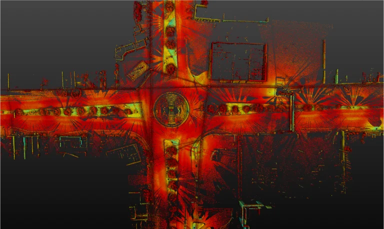 Nube de puntos una vista aérea de infrarrojos térmicos de la Intersección Vial El Pípila, que presenta una intersección de cuatro vías con una rotonda, destaca los patrones de calor rojo y naranja brillantes en las carreteras, rodeadas de edificios de tonos verdes y amarillos más fríos