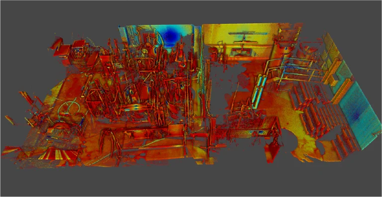 Un colorido escaneado en 3D de la Planta Industrial Sukarne muestra maquinaria, tuberías y equipos dispuestos por toda la sala industrial, vistos desde una perspectiva descendente sobre un fondo gris oscuro