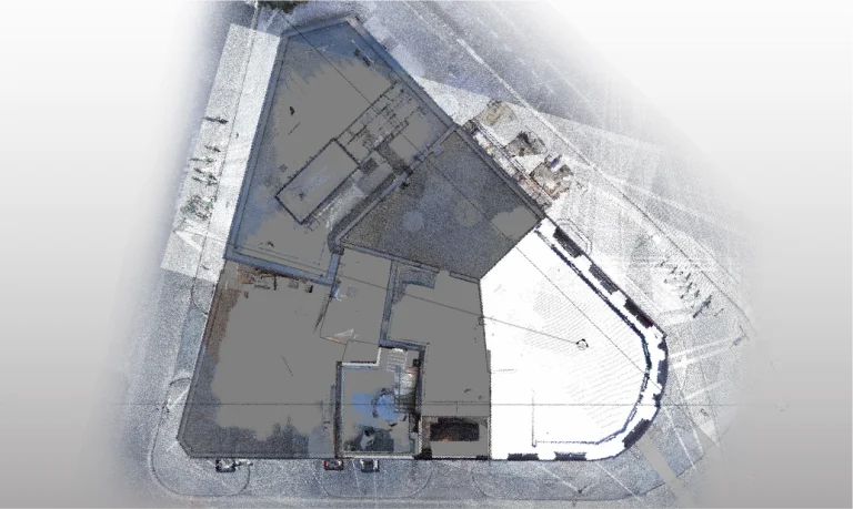 Vista aérea del complejo GGM 115 Londres en una manzana triangular; se muestra como un renderizado digital de nube de puntos con sombreados y los tenues contornos de las aceras y calles cercanas