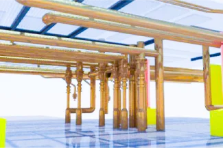 A digital rendering of a building's exposed plumbing system at the Tamazula Sugar Mill shows copper and pink pipes connected under a ceiling, with bright yellow structural supports above a reflective blue floor.