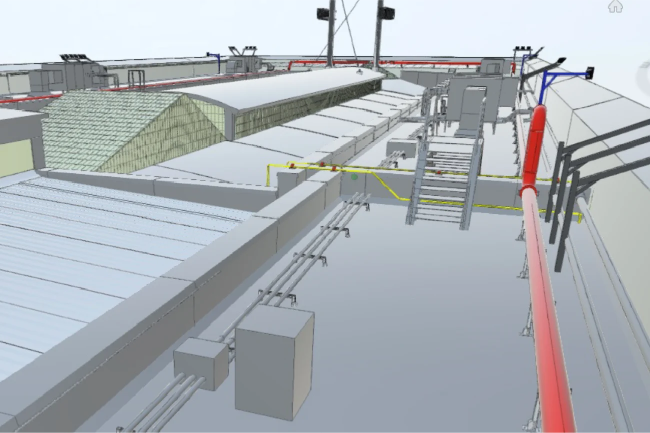 Modelo 3D de la azotea de un edificio, inspirado en el Aeropuerto Internacional de Tijuana, que presenta tuberías, bandejas de cables, una escalera, unidades de equipo y una estructura de techo inclinado. Las líneas rojas, amarillas y negras indican los diferentes servicios que discurren por la azotea.