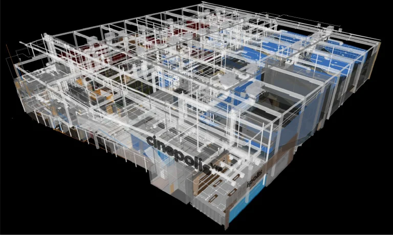 Modelo digital en 3D de la estructura interior de un edificio, con paredes transparentes y tuberías, cableado y elementos arquitectónicos visibles. La palabra Cinépolis aparece en una de las paredes interiores, lo que sugiere que se trata del cine Mitikah