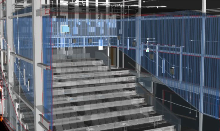 Representación digital del interior del edificio de Cinépolis Mitikah con una escalera, vigas estructurales, paredes transparentes y sistemas visibles de calefacción, ventilación y electricidad dentro de un detallado modelo arquitectónico en 3D