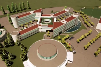 BIM Model Aerial view of the modern, multi-wing building complex of the Tecnológico de Monterrey in Puebla, featuring curved roofs, circular structures, glass windows, surrounding trees, parking lots, and landscaped green areas.