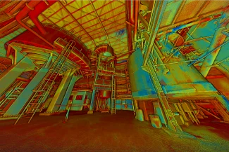 A colorful, digitally altered image of the industrial interior of the Tamazulas Sugar Mill, featuring large tanks, pipes, ladders, and metal structures in vibrant red, yellow, and blue beneath a high, grid-patterned ceiling.