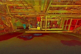 Colorful and stylized image of an industrial interior at the Tamazula Sugar Mill in Jalisco, featuring pipes, beams, ladders, machinery, and two wagon wheels. The bright red, yellow, and green hues give the sugar scene a surreal, heat-map-like appearance.