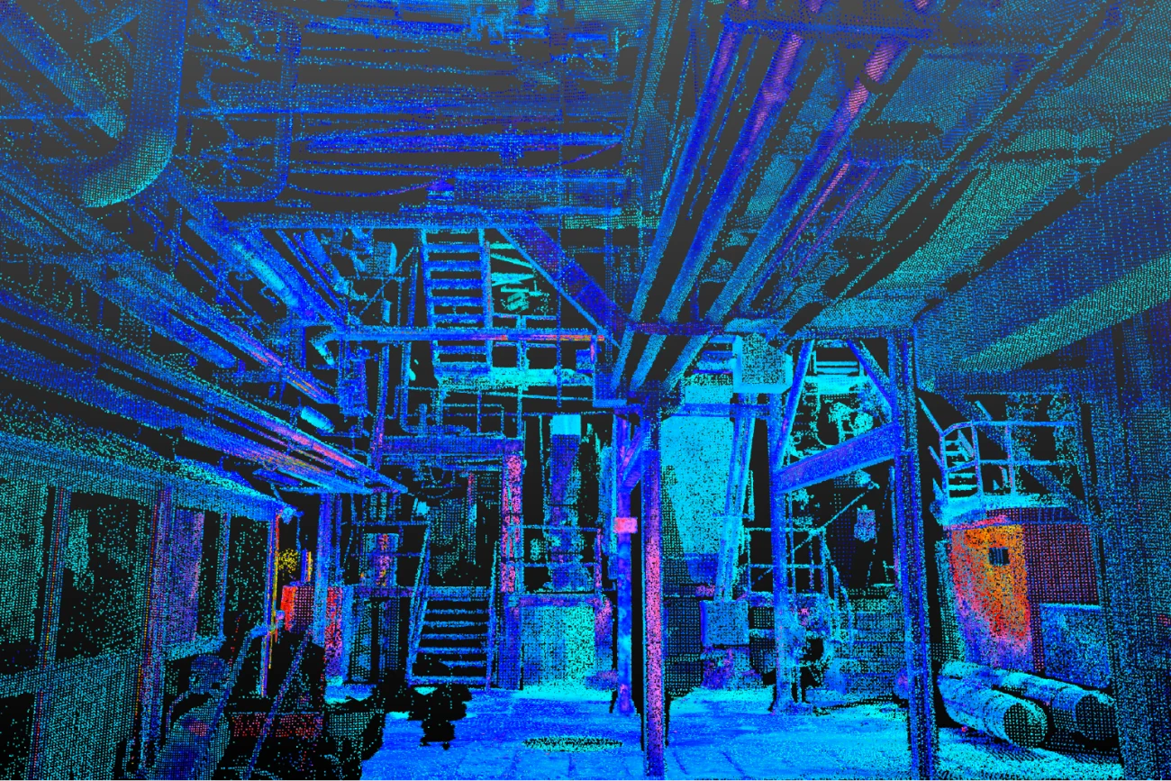 A colorful, digitally enhanced image of an industrial interior at the Tamazula Sugar Mill, with pipes, beams, and metal structures bathed in hues of blue, green, and purple; ladders and machinery are visible throughout the scene.