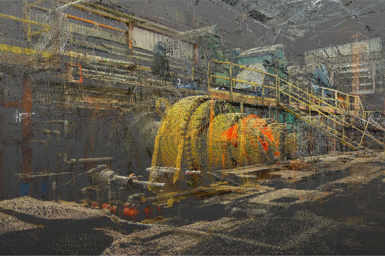 A digitally rendered point cloud image of industrial equipment in a large warehouse at Ingenio Azucarero Tamazula, featuring yellow machinery, railings, and walkways with various pipes and metal structures in the background.