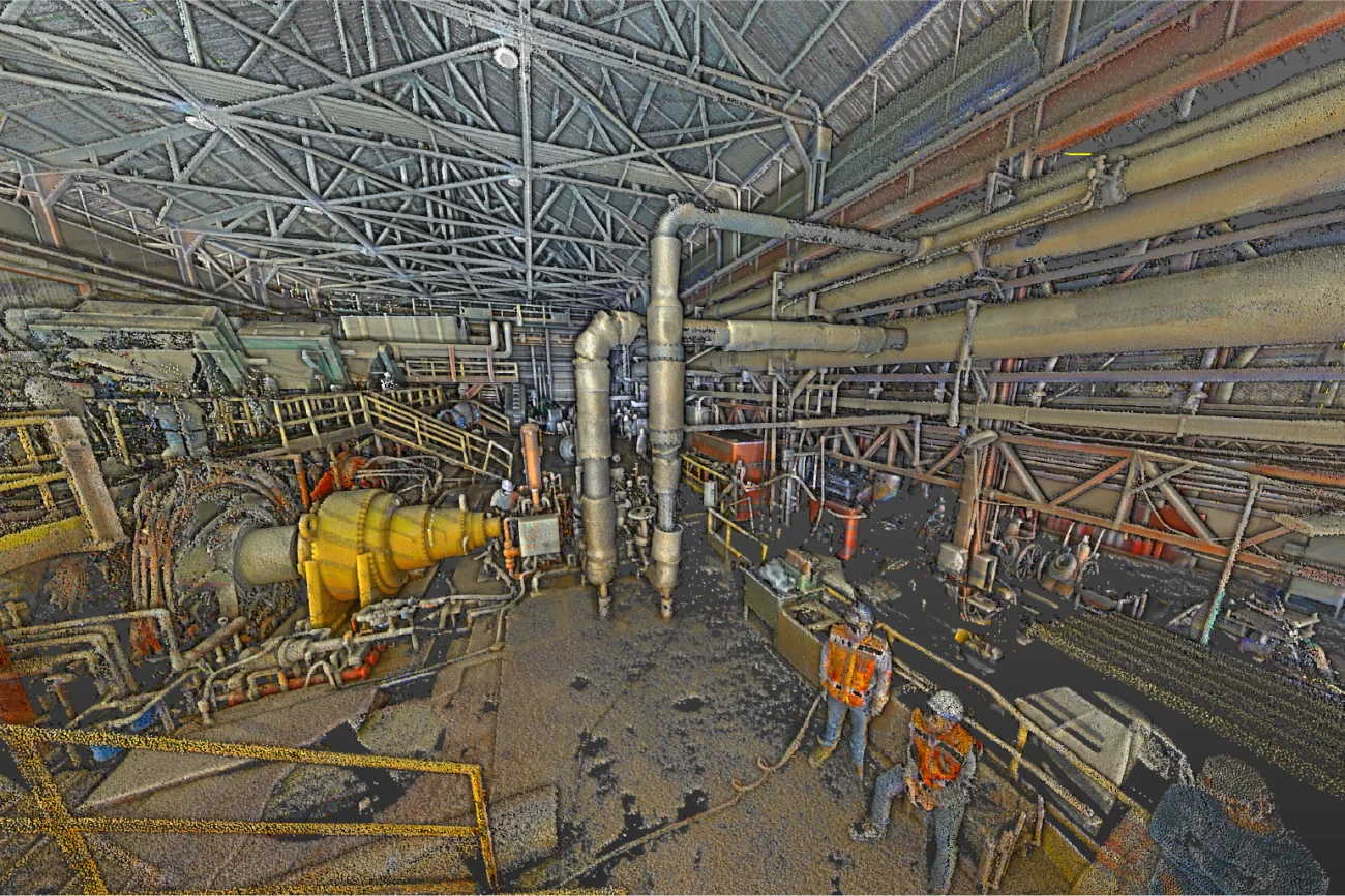 Inside the Tamazula Sugar Mill in Jalisco, an industrial facility bustles with workers in safety gear tending to large pipes and machinery, all dedicated to producing sugar under a high, open roof.