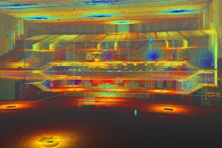 Una colorida nube de puntos escaneada en 3D del interior del Auditorio Blackberry, que muestra filas de asientos, balcones, escaleras y luces, con vibrantes tonos amarillos, naranjas, rojos, azules y verdes que resaltan los detalles arquitectónicos.