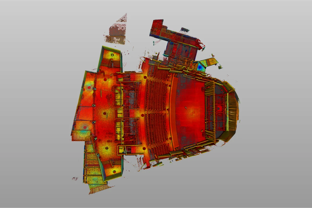 Una nube de puntos escaneada de arriba abajo y codificada por colores del Auditorio Blackberry de Ciudad de México muestra los asientos, el escenario y los balcones, con tonos rojos y amarillos que resaltan las elevaciones y las características sobre un fondo gris claro de esta famosa sala de conciertos.
