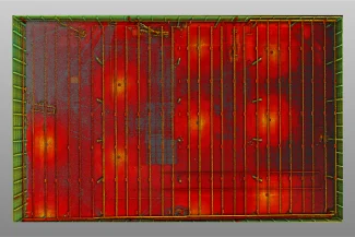 Aerial view of a square red metal surface with parallel greenish-yellow beams, some visible rust and discoloration. The edge is green with bolts, resembling the industrial roof of a BMW Industrial Plant or a shipping container.