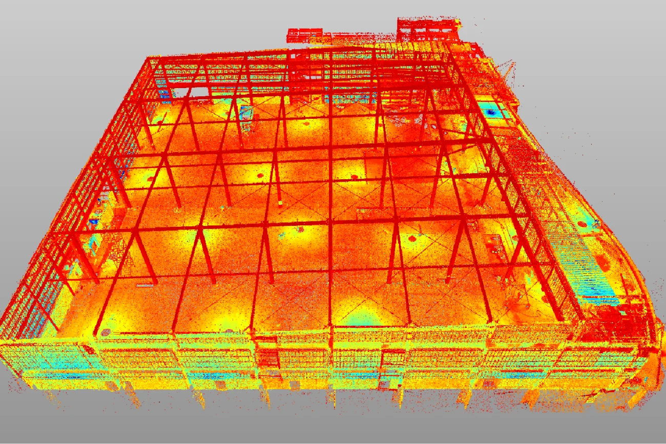 Nube de puntos escaneada en 3D de la estructura del edificio de Cinépolis Mitikah, en vibrantes colores rojo, naranja y amarillo, que destacan el entramado reticular y las plantas interiores abiertas.