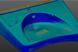 A 3D scan of a rectangular object with a curved front and raised section, labeled VITA in yellow text, features a mix of blue, green, and orange colors on a gray background, perfect for Grupo Corona Muebles Baños' collections.