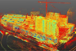 A colorful 3D point cloud image of the Sentura Tlalnepantla Shopping Center under construction, with distinctive red, yellow, and blue dots forming the structure and a crane visible in the background.