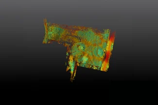Abstract digital artwork simulating a topographic survey, featuring layered textured patterns of green, yellow, orange, and red forming a roughly rectangular shape on a dark gray gradient background. The image has an organic, weathered look.