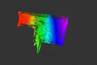 Point cloud that transitions from red to purple on a dark gray background, evoking the layers and gradients seen in Topographic Surveying.