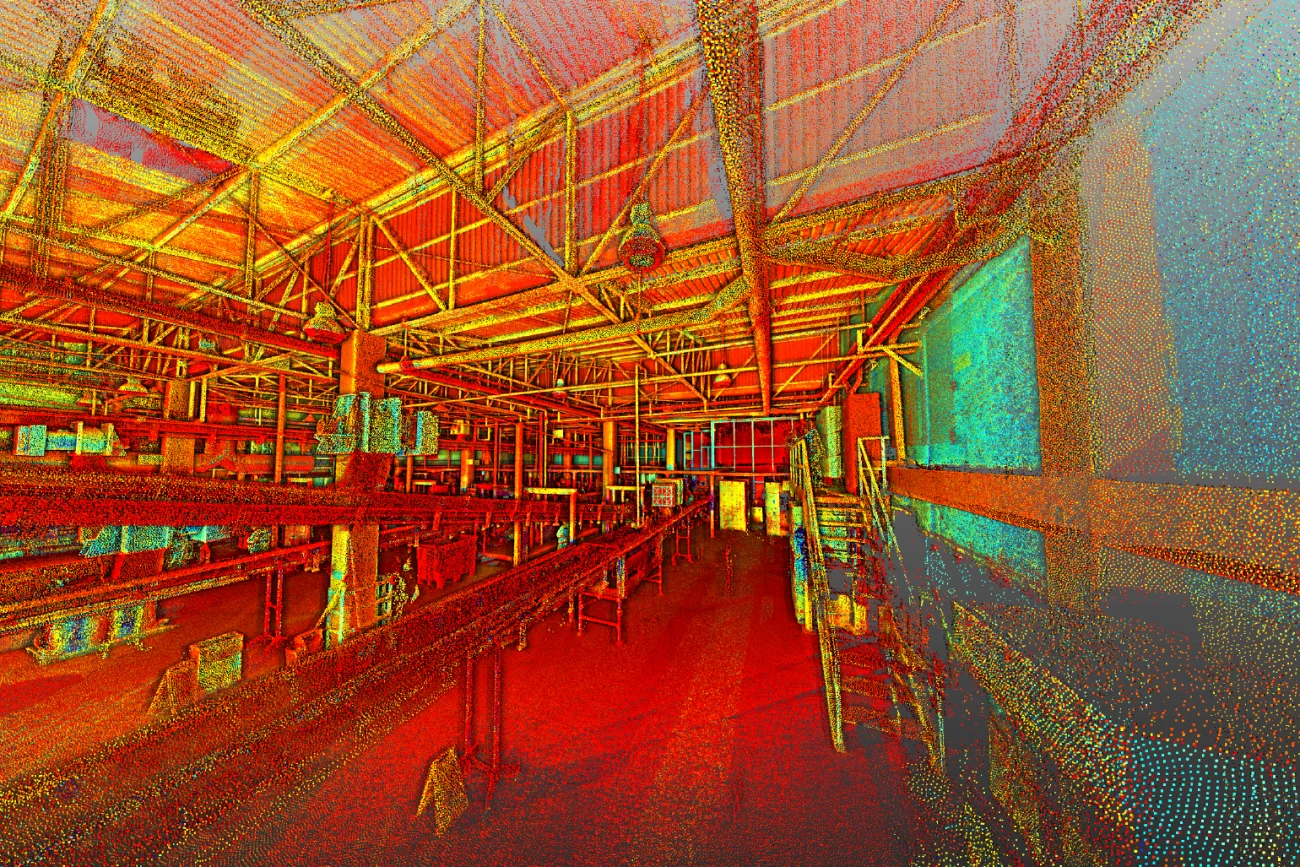 Colorful point cloud image of a large industrial plant warehouse interior, showing metal beams, shelves, and a staircase, with vibrant red, yellow, blue, and orange hues creating a digital, abstract effect.