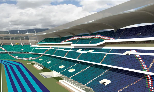 A large, modern Pascual Guerrero Stadium with blue and green seats under a curved white roof. The seating sections have red, white, and green patterns, and the field features blue track lanes. A partly cloudy sky is visible above.