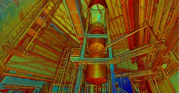 Una imagen LiDAR vibrante y coloreada del interior de una instalación industrial, con vigas metálicas, tuberías y una gran estructura cilíndrica en el centro, vista desde abajo con un intenso efecto de filtro rojo, amarillo y azul.