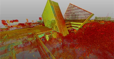 Un colorido renderizado 3D de nubes de puntos, creado con LiDAR en Monterrey, muestra dos modernos edificios angulares y los árboles que los rodean. El aspecto digital pixelado resalta las características arquitectónicas y la vegetación local.